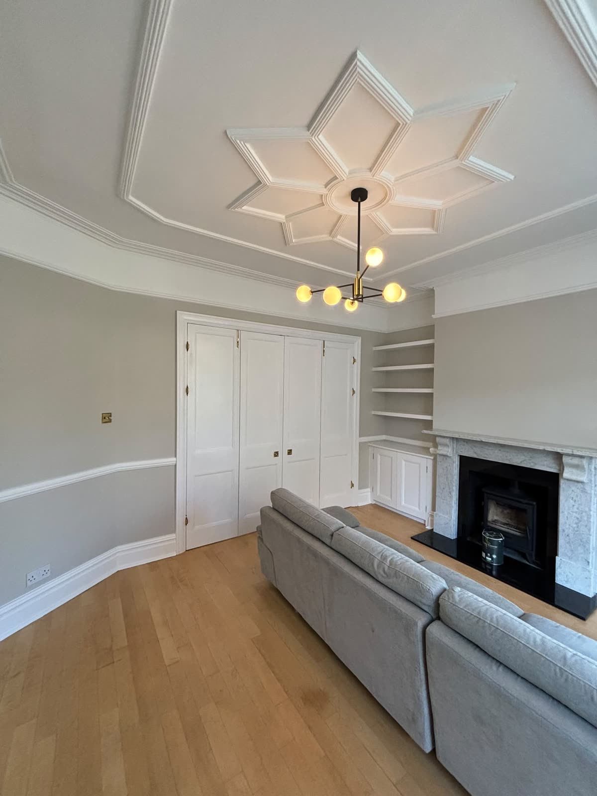 Panelled double cupboards under a star ceiling with brass fittings